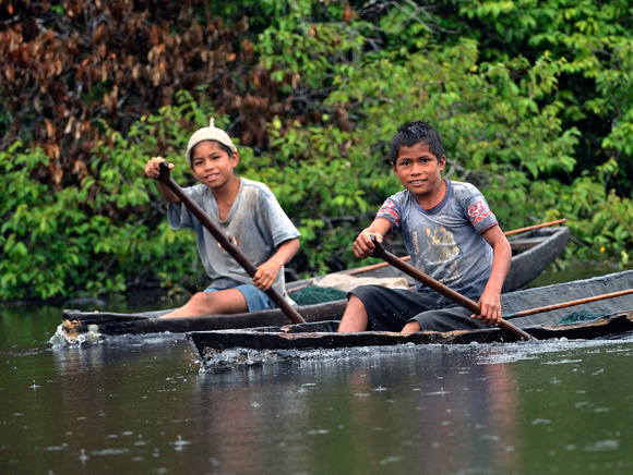 Peruvian Boys in Dugpout Canoes Peruvian Amazon