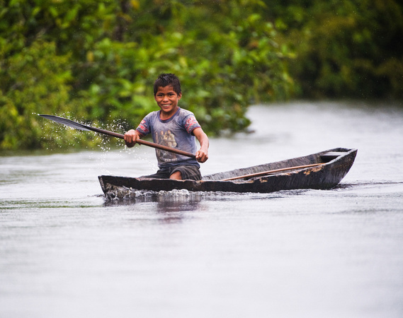 Peruvian Boy in Canoe Amazon